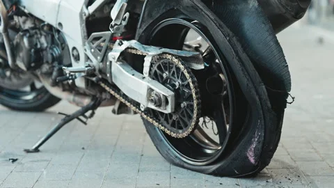 Slow motion video of explosive motorcycle tire burst captures intense action and Video stock 277582251