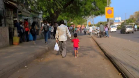 Slow motion video of a father and his son walking down the street Stock Footage