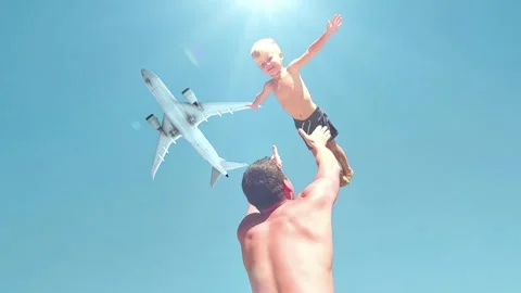 Slow motion video. Father throws son up when they play on the beach. Plane Video stock 250215789