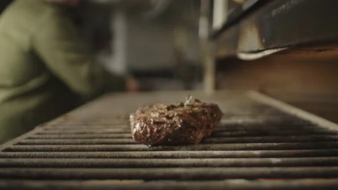 Slow-motion video of flipping a steak being grilled. Stock Footage 239008061