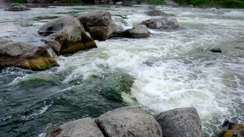 Slow motion video of flowing river among the stones at spring. Nature riversi Stock Footage 150353080