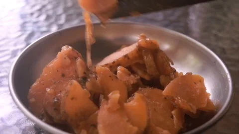 Slow motion video of fresh picked red potatoes slices being poured onto a bowl Video stock 337435178