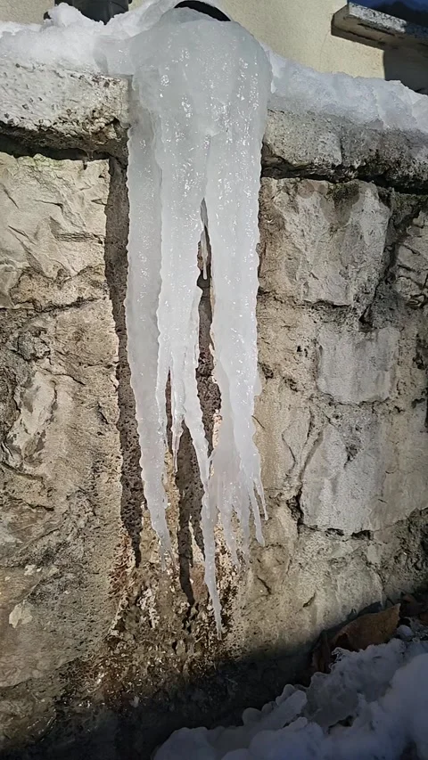 Slow motion video of a giant melting ice stalactite Stock Footage 321693985