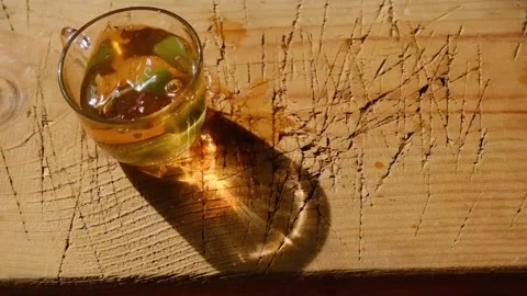 Slow motion video. A green candy dropping into the a glass cup and pot Video stock 151052740