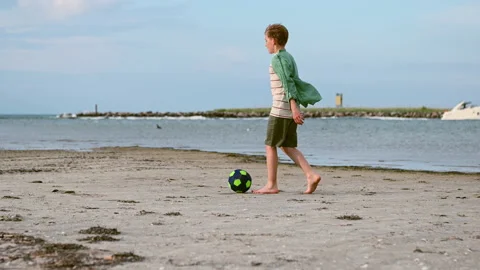 Slow motion video of happy boy playing with ball on beach during sunset Stock-Footage 155806102