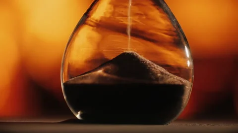 Slow motion video of Hourglass clock against the background of the fireplace Stock Footage 147855838