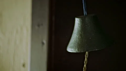 Slow motion video of a human hand ringing a bell. Stock Footage 155828232