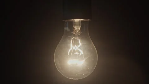Slow motion video of the light in the bulb turning on and then turning off. Stock Footage 309535717