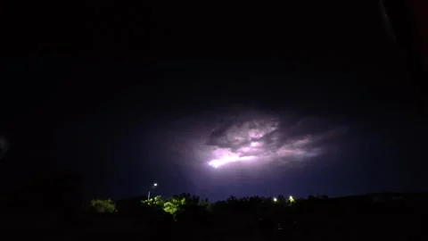 A slow-motion video of a lightning bolt illuminating the sky Stock Footage 345611232