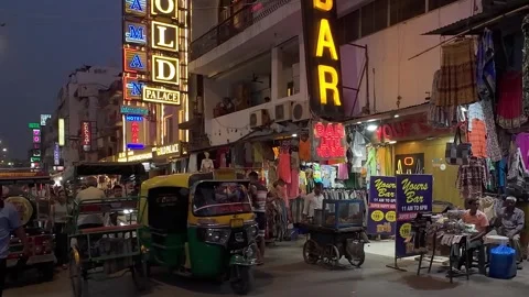 Slow motion video of the Main Bazar road with buzy traffic late in the evening Stock Footage 279184853