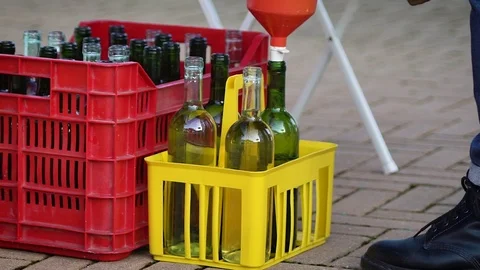 Slow motion video of the man refilling wine bottles with white wine selec Stock Footage 71556423