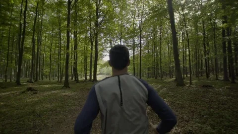 Slow motion video of man running in the woods Video stock 72183892