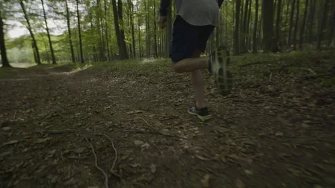 Slow motion video of man running in the woods Stock Footage 72184401