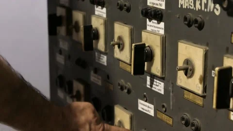 A slow motion video of a man's hand turning an old remote control key on a plant Video stock 201414229