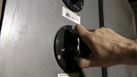 A slow motion video of a man's hand turning an old remote control key on a plant Video stock 201414250