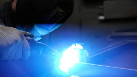 Slow motion video. Masked worker. Metal welding Stock Footage 153660606