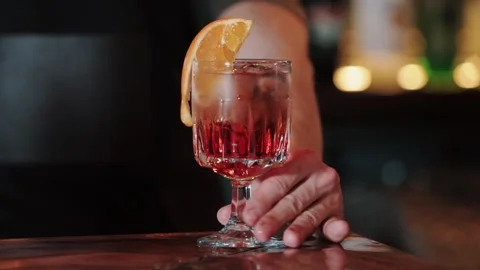 A slow motion video of a mixologist making an Aperol-Spritz cocktail. pours Stock Footage 306773953