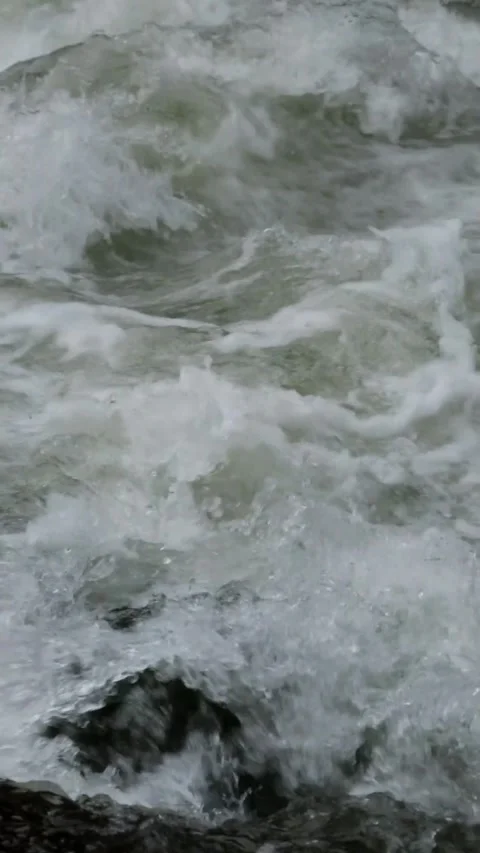 Slow motion video of mountain river water passing through a rocky cascade Stock Footage 297716167