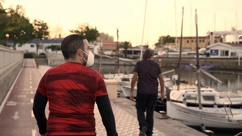 Slow motion video of a new normal situation: a man in Spain wearing a protect 스톡 동영상 129616142