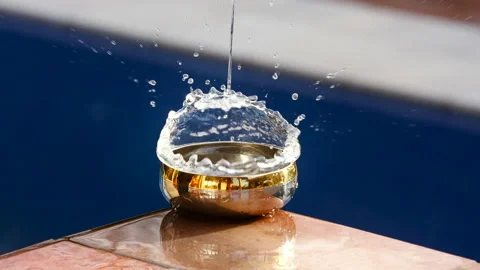Slow motion video of an object dropping into the water of a bowl and water Stock Footage 231461129