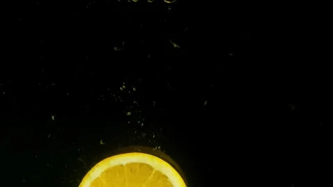 Slow-motion video of an orange falling into water. Stock Footage 260298871