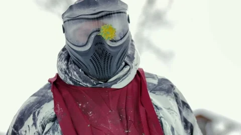 Slow motion video of a paintball player in winter who is wearing a mask Stock Footage 231807673