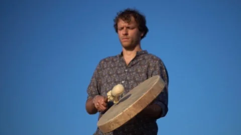 Slow motion video of a percussionist playing an ancient shamanic drum Video stock 113547951