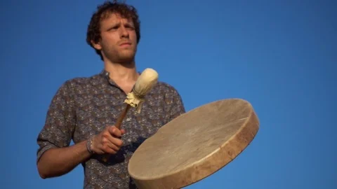 Slow motion video of a percussionist playing an ancient shamanic drum Video stock 113547952
