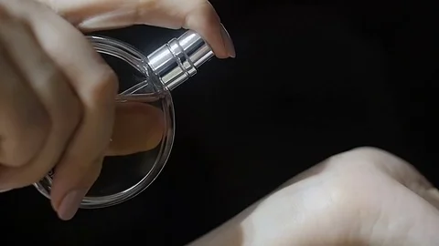 Slow-motion video of perfume, sprayed hand girl Stock Footage 73033268