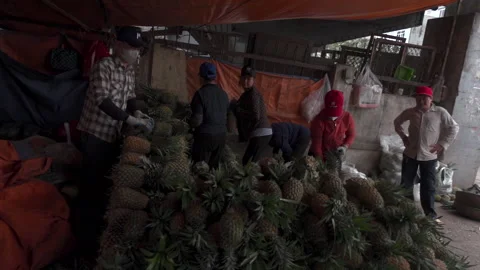 Slow motion video of pineapple stall in a local market with people Stock Footage 272284695