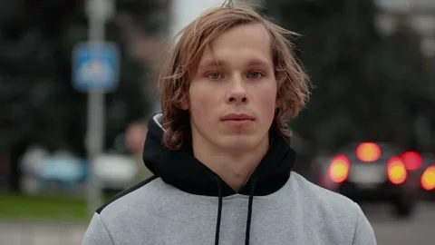 Slow motion video portrait of young man looks at a camera in the city Stock Footage 142995210