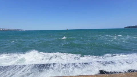 Slow motion video of a powerful ocean wave crashing against a pier, creating Stock Footage 317618493