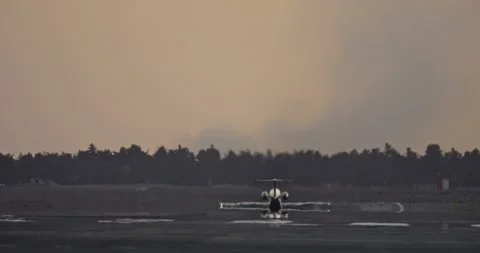 Slow motion video of a private jet taking off from the runway at sunset. Stock Footage 293285998