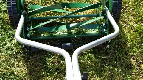 Slow motion video of a push lawn mower with rotating blades. Stock Footage 110440732
