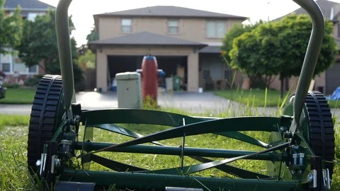 Slow motion video of a push lawn mower with rotating blades. Stock Footage 110441943