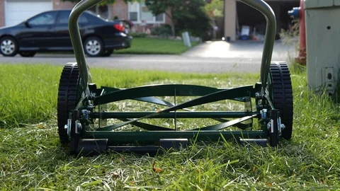 Slow motion video of a push lawn mower with rotating blades. Stock Footage 110444566