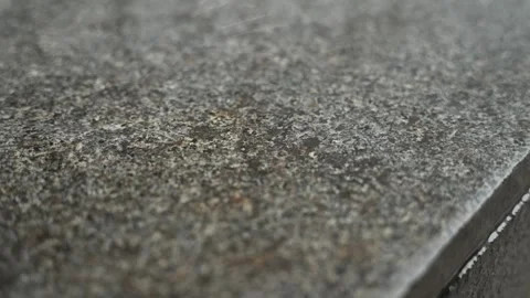 Slow-motion video of raindrops rolling across a marble surface. Stock Footage 311584756