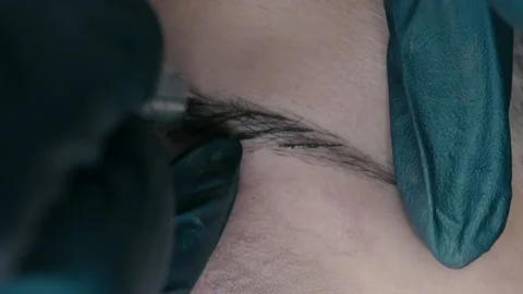 Slow motion video recording of microblading work. Permanent makeup on the brow. Stock Footage 223159034