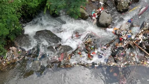 Slow motion video of river rapids flowing through plastic waste. Stock Footage 336322216