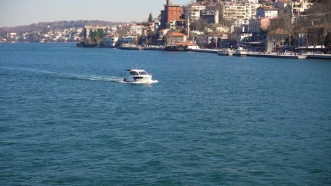 Slow motion video. Sailing along the shore of Bosphorus on a small motor yach Video stock 88778424