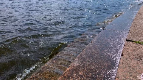 Slow motion video of the shocking waves of a river on a stone pier Stock Footage 115565218