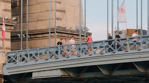 SLOW MOTION VIDEO SHOT of Group of young men walking over bridge in BUDAPEST 動画素材 92685805
