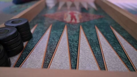 Slow motion video shows a hand throwing dices on a backgammon board. Stockbeeldmateriaal 150683544