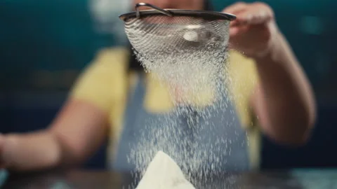 Slow motion video of sifting flour through a sieve. Stock Footage 240568622