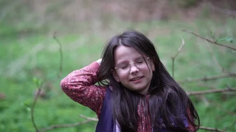 Slow motion video of a small beautiful smiling girl in the forest Stock Footage 276081640