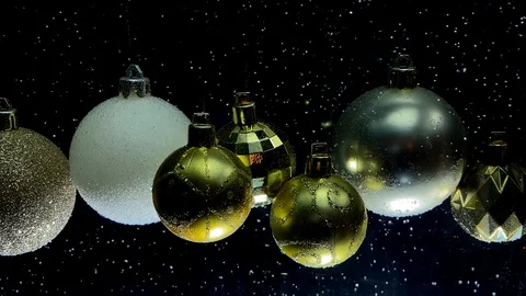 Slow motion video snowfall and different christmas balls Video stock 121632644
