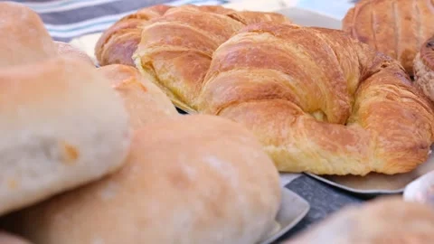 Slow motion video of some freshly french buttered croissants. Video stock 208230248