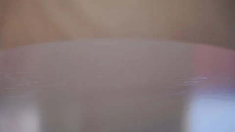 Slow motion video of some multicolored big polymer water balls that grow when Video stock 130248306