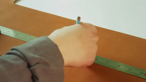 Slow-motion video of a tailor's hands making a close-up marking and cutting line Stock Footage 143720614