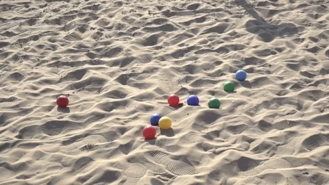 Slow motion video of three Boccia balls landing in sand Stock Footage 92585228